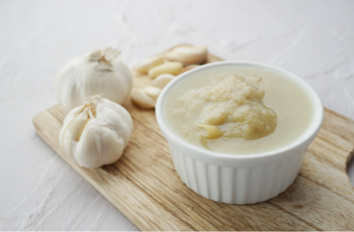 Garlic is a potent flavor enhancer known for its bold taste and health benefits, especially when roasted or sautéed.