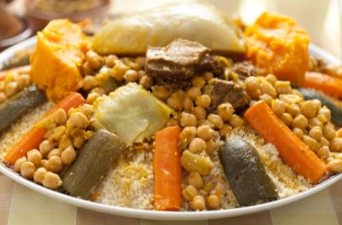 The image illustrates ONE of the most iconic dishes associated with food in Morocco, highlighting the beloved couscous as central component of Moroccan cuisine