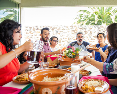 The image captures the essence of food in Morocco, emphasizing its integral role in social and family gatherings. Meals are typically enjoyed in a communal setting, with diners sharing a large dish that fosters connection and conversation