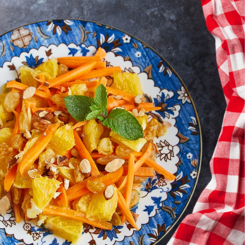 A colorful Moroccan Carrot Salad with shredded carrots, olive oil, lemon juice, and cumin.