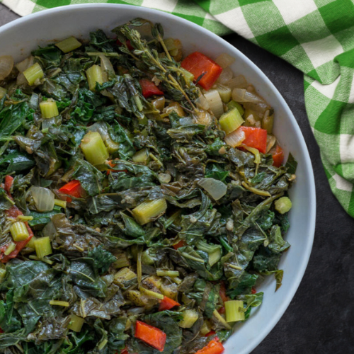 A vibrant bowl of Caribbean Callaloo, featuring spinach, okra, and coconut milk, perfect for plant-based diets in children.