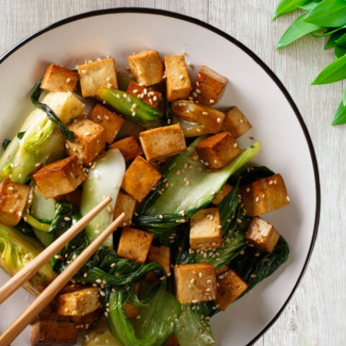 Stir-fried tofu and bok choy glazed with soy sauce and sesame oil, perfect for plant-based diets in children.