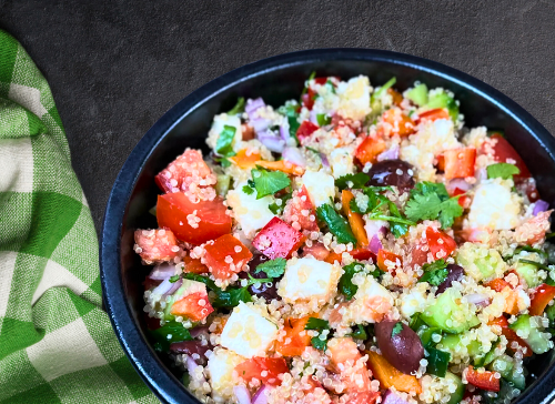 A colorful Peruvian Quinoa Salad with corn, black beans, and cilantro, drizzled with lime juice. Ideal for kids on plant-based diets.